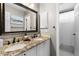 Bathroom featuring double sinks, granite countertops, a large mirror, and an open shower at 446 Angus Way, Highlands Ranch, CO 80129