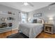 Cozy bedroom with hardwood floors, ceiling fan, natural light, and stylish decor at 446 Angus Way, Highlands Ranch, CO 80129