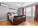 Bedroom featuring a large window, a ceiling fan, hardwood flooring, and a comfortable bed at 446 Angus Way, Highlands Ranch, CO 80129