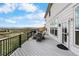The deck has chairs, a dining table, and views of the yard and mountains at 446 Angus Way, Highlands Ranch, CO 80129