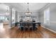 Bright dining room with hardwood floors, modern chandelier, and windows with custom shutters at 446 Angus Way, Highlands Ranch, CO 80129