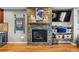 A stylish stone fireplace with wooden mantel shelves is featured in the living room at 446 Angus Way, Highlands Ranch, CO 80129