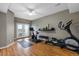 Well-lit home gym with various exercise equipment and french doors at 446 Angus Way, Highlands Ranch, CO 80129