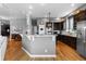 Open kitchen layout with dark wood cabinetry, granite countertops, and stainless steel appliances at 446 Angus Way, Highlands Ranch, CO 80129