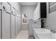 Practical laundry room with utility sink, cabinet storage, and washer/dryer at 446 Angus Way, Highlands Ranch, CO 80129