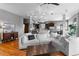 Open-concept living area featuring hardwood floors, stone fireplace, lots of natural light, and modern decor at 446 Angus Way, Highlands Ranch, CO 80129