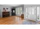 Sunlit living room features beautiful hardwood floors, neutral paint, decorative windows, and plenty of natural light at 446 Angus Way, Highlands Ranch, CO 80129