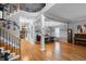 Spacious living room with beautiful hardwood floors, grand staircase, dining area, and elegant decor at 446 Angus Way, Highlands Ranch, CO 80129