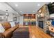 The living room includes a stone fireplace, a dry bar, and wood flooring at 446 Angus Way, Highlands Ranch, CO 80129
