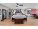 Large bedroom featuring hardwood floors, a ceiling fan, and stylish decor with comfortable furniture at 446 Angus Way, Highlands Ranch, CO 80129