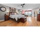 Spacious bedroom with hardwood floors, ceiling fan, sitting area, and ensuite bathroom at 446 Angus Way, Highlands Ranch, CO 80129