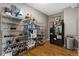 Walk-in pantry with ample shelving for storage, alongside a black refrigerator at 446 Angus Way, Highlands Ranch, CO 80129