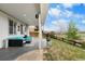 A covered patio is equipped with outdoor seating, a fireplace, and grass at 446 Angus Way, Highlands Ranch, CO 80129