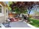 Spacious backyard featuring a brick patio, mature trees, and a well-maintained lawn for outdoor enjoyment at 1089 E 131St Dr, Thornton, CO 80241