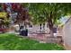Lush backyard featuring mature trees, brick and concrete patios, and outdoor seating for entertaining at 1089 E 131St Dr, Thornton, CO 80241