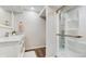 Modern bathroom featuring wood flooring, a shower with a glass door, and a marble vanity sink at 1089 E 131St Dr, Thornton, CO 80241