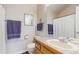Cozy bathroom featuring tiled countertops and floors with built in storage for essentials at 1089 E 131St Dr, Thornton, CO 80241