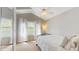 Bright bedroom with vaulted ceiling, ceiling fan, and sun-drenched windows with sheer white curtains at 1089 E 131St Dr, Thornton, CO 80241