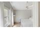 Bright bedroom with vaulted ceiling, ceiling fan, and sun-drenched windows with sheer white curtains at 1089 E 131St Dr, Thornton, CO 80241