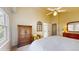 This bedroom has a tall armoire, a small armchair, and large windows at 1089 E 131St Dr, Thornton, CO 80241