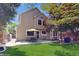 Two-story home featuring a well-manicured lawn, a patio, and mature trees for curb appeal at 1089 E 131St Dr, Thornton, CO 80241