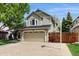 Two-story home featuring a two-car garage, spacious driveway and basketball hoop at 1089 E 131St Dr, Thornton, CO 80241