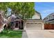 Charming home featuring a two-car garage, inviting porch, and beautiful landscaping at 1089 E 131St Dr, Thornton, CO 80241