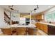 This kitchen boasts an island with seating, stainless steel appliances, and stylish track lighting at 1089 E 131St Dr, Thornton, CO 80241