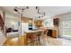Bright kitchen features a center island with bar stool seating, wood cabinets, and unique overhead lighting at 1089 E 131St Dr, Thornton, CO 80241
