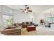 This living room has vaulted ceilings, plush sofas, and large windows that provide natural light at 1089 E 131St Dr, Thornton, CO 80241