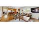 Open-concept living room with wood floors that connects to the kitchen at 1089 E 131St Dr, Thornton, CO 80241