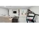 Spacious living room with a sectional sofa, bookshelves, and exercise area at 1089 E 131St Dr, Thornton, CO 80241