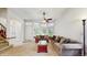 Bright living room featuring large bay windows, neutral carpet, and comfortable couches at 1089 E 131St Dr, Thornton, CO 80241