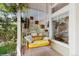 Inviting porch with a comfortable swing, lattice accents, and lush greenery for relaxation at 1089 E 131St Dr, Thornton, CO 80241