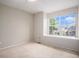 Clean bedroom bathed in light from a large window at 2786 S Cathay Way, Aurora, CO 80013
