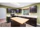 Well-equipped kitchen with stainless steel appliances, central island, and dark cabinetry at 2786 S Cathay Way, Aurora, CO 80013