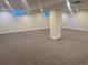 A spacious basement featuring neutral walls and carpet, complemented by recessed lighting and small windows at 5720 E Caley Ave, Centennial, CO 80111