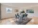 Sun-filled dining room featuring new hardwood floors, wainscotting, and a contemporary dining set at 5720 E Caley Ave, Centennial, CO 80111