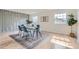Sun-filled dining room featuring new hardwood floors, wainscotting, and a contemporary dining set at 5720 E Caley Ave, Centennial, CO 80111