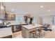 Open-concept kitchen with quartz countertops, stainless steel appliances, and an island with seating at 5720 E Caley Ave, Centennial, CO 80111