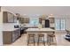Open-concept kitchen with quartz countertops, stainless steel appliances, and a center island with seating at 5720 E Caley Ave, Centennial, CO 80111