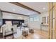 Bright living room features hardwood floors, a modern fireplace, and wood beams at 5720 E Caley Ave, Centennial, CO 80111