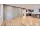 Spacious living room with hardwood floors adjacent to a newly renovated kitchen with stainless appliances at 5720 E Caley Ave, Centennial, CO 80111