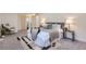 Comfortable main bedroom with a plush bed, stylish rug, and ample natural light at 5720 E Caley Ave, Centennial, CO 80111