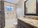 Bathroom features a shower-tub combo, granite countertops, and sink at 11197 W 64Th Pl, Arvada, CO 80004