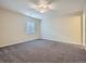 Spacious bedroom with neutral carpet, a ceiling fan, and natural lighting at 11197 W 64Th Pl, Arvada, CO 80004