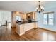 Modern kitchen featuring black countertops, stainless steel appliances, and an elegant chandelier at 11197 W 64Th Pl, Arvada, CO 80004