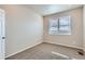 Cozy bedroom with neutral walls, plush carpeting, and a window allowing natural light at 8830 Sedalia St, Commerce City, CO 80022