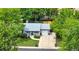 Aerial view of home with a well-maintained lawn and mature trees at 6943 Ingalls St, Arvada, CO 80003