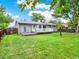 Backyard with a gray deck and green grass at 6943 Ingalls St, Arvada, CO 80003
